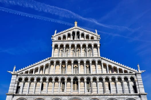 The Duomo of Pisa with a blue sky behind.
