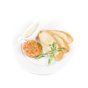 Tar-tar from salmon fish with green onion. Served with honey sauce and white bread toast.