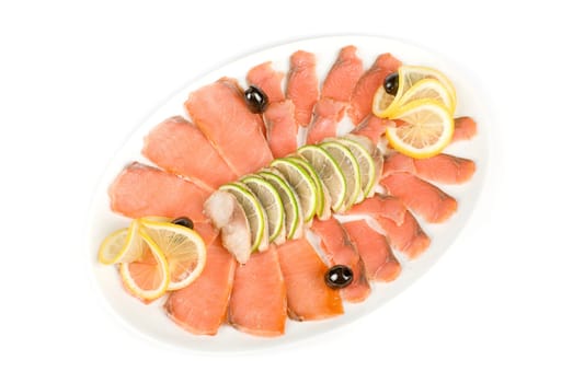 Sliced chum salmon and mackerel closeup decorated with limes, lemons and olives
