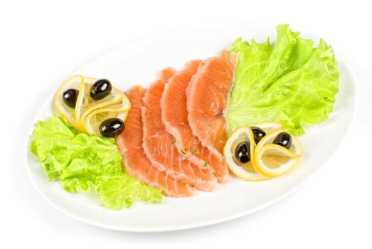 Salmon closeup with lettuce, lemon and olive on white background