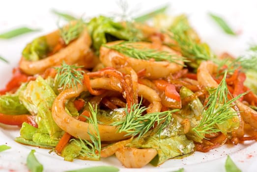 Seafood salad with squid and vegetables closeup