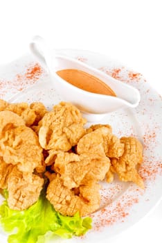 Deep-fried tiger shrimp with salad leaves, sauce closeup