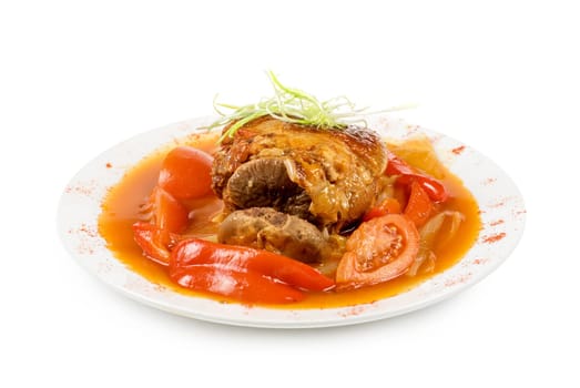 knuckle of veal baked with vegetables closeup