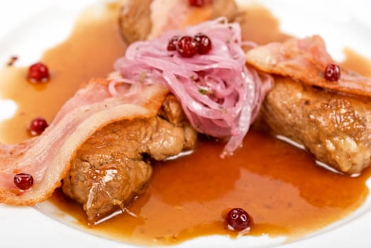Roast pork meat with bacon, onion and cranberries