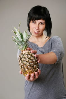 Young woman with pineapple
