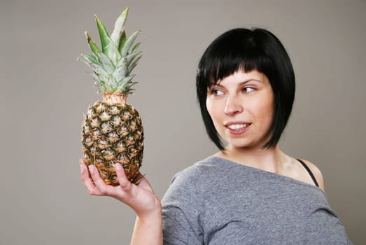 Young woman with pineapple