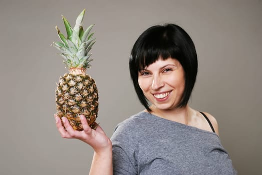 Young woman with pineapple
