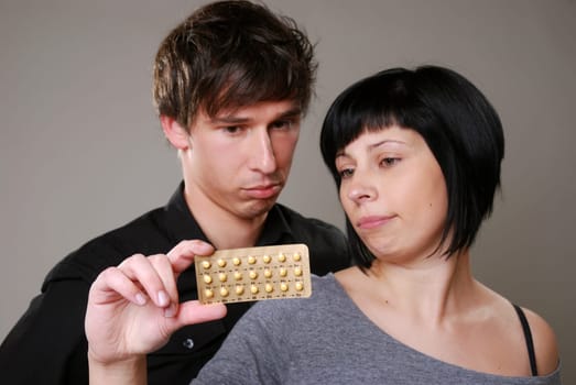 Young couple with birth control pill