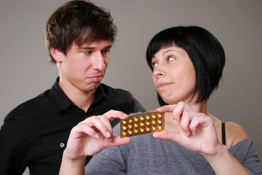 Young couple with birth control pill