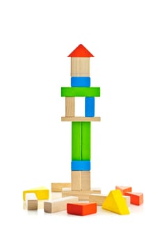 Tower of wooden building block toys isolated on white background