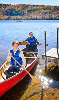 Father and daughter canoeing on Lake of Two Rivers, Ontario, Canada