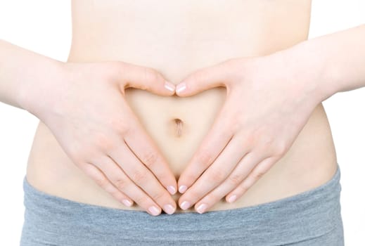 Woman showing heart shape with her hands on stomach
