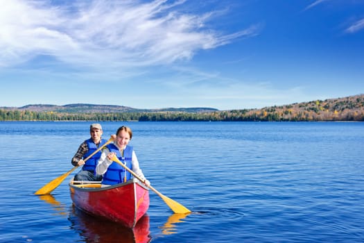 Father and daughter canoeing on Lake of Two Rivers, Ontario, Canada