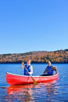 Family canoeing on Lake of Two Rivers, Ontario, Canada