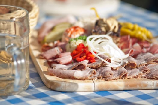 Austrian traditional plate of cold-cuts with self-made ingredient on wooden plate