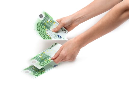 Hands of the girl considers euro on white background
