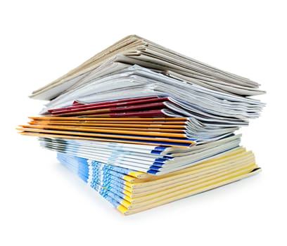 Printed paper publications stacked in a pile isolated on white