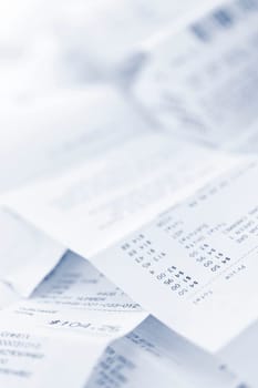 Paper cash register receipts in a lose pile close up