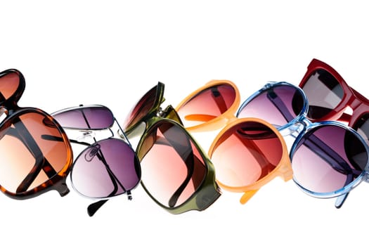 Different styles of tinted sunglasses on white background