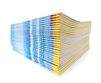 Many magazines stacked in a pile isolated on white