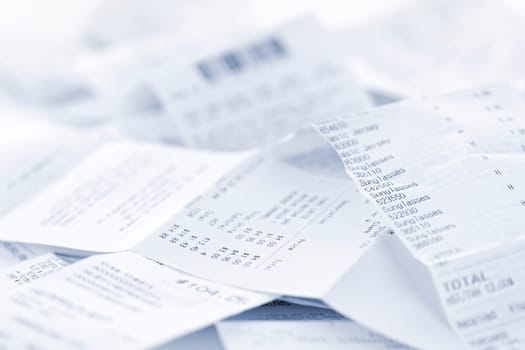 Paper cash register receipts in a lose pile close up