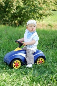 Boy with ride-on car