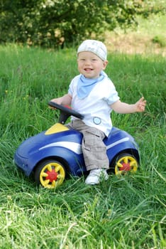 Boy with ride-on car