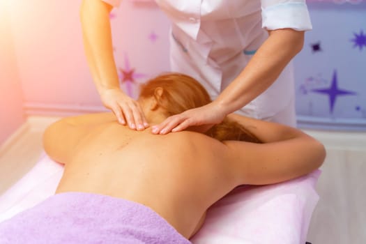 Top view of hands massaging female abdomen.Therapist applying pressure on belly. Woman receiving massage at spa salon.