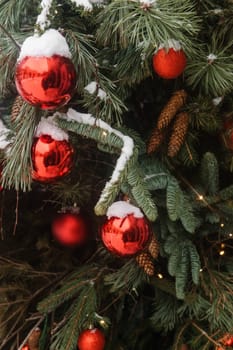 Christmas trees decorated with red balloons in front of the cafe entrance. Street Christmas decorations