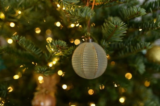 Green ball toys hanging on a Christmas tree