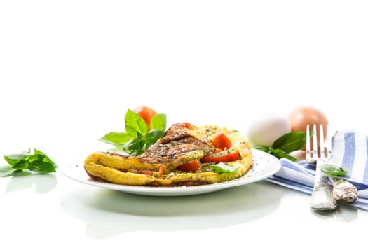 Stuffed omelette with tomatoes isolated on white background. Healthy diet food for breakfast.