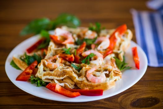 Fried simple omelette with shrimp and vegetables in a plate, on a wooden table.