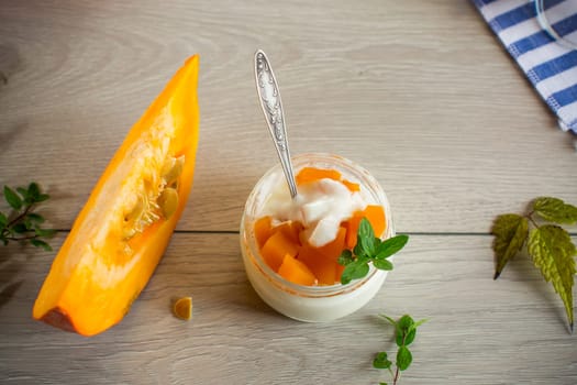 Homemade yogurt with pieces of pumpkin marmalade. Autumn recipes.
