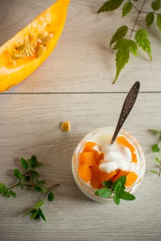 Homemade yogurt with pieces of pumpkin marmalade. Autumn recipes.