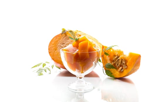 Prepared sweet pumpkin marmalade in a glass bowl isolated on a white background. Autumn recipes.