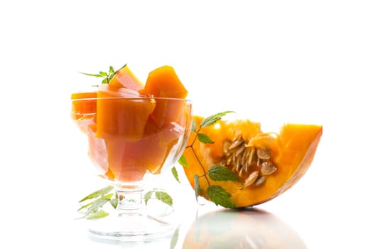 Prepared sweet pumpkin marmalade in a glass bowl isolated on a white background. Autumn recipes.
