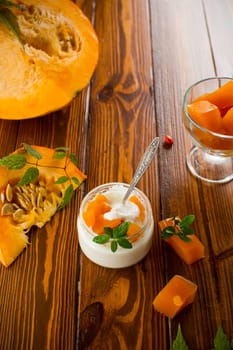 Homemade yogurt with pieces of pumpkin marmalade. Autumn recipes.