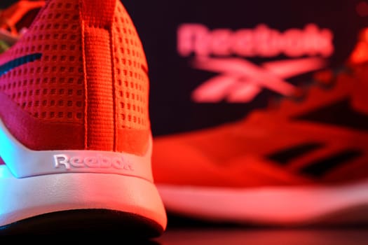 Tyumen, Russia-August 03, 2023: Reebok mens model Nanoflex in the red light. Selective focus