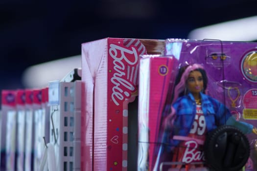 Tyumen, Russia-September 19, 2023: Barbie logo on a box with dolls, on the shelf of a hypermarket. Selective focus