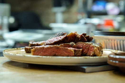 Delicious beef steak. Cooked meat on a wooden kitchen board. Shallow depth of field