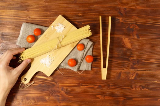 Spaghetti on a rustic background. Yellow Italian pasta. Long spaghetti. Raw spaghetti.