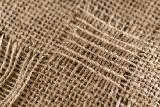 Jute fabric with shadow and natural light. Vintage background. Selective focus