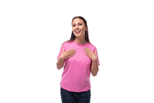 young stylish brunette lady dressed in a pink t-shirt feels optimistic.