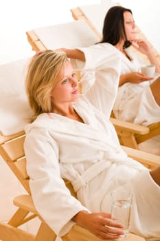 Relax luxury spa beauty women enjoy refreshments lying on sun-beds