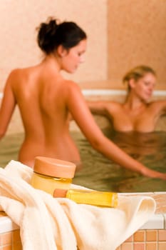 Spa and beauty products two naked women inside pool water beauty health