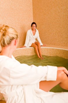Relax bath healthy spa two beauty woman sitting bathrobe pool
