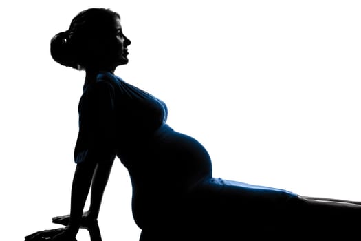 beautiful caucasian pregnant woman in silhouette on studio isolated white background