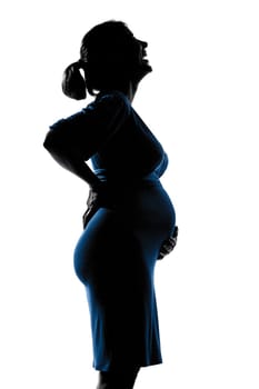 beautiful caucasian pregnant woman in silhouette on studio isolated white background