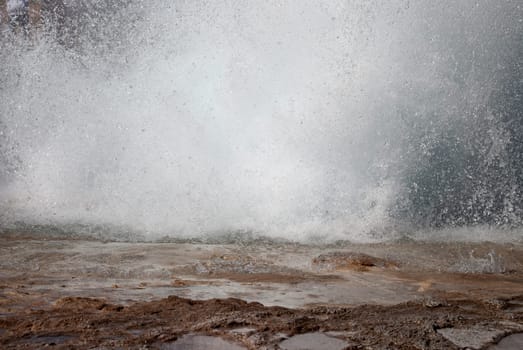 detail of the base of a geyser erupting