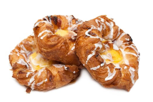 Three puff cakes with vanilla on white background